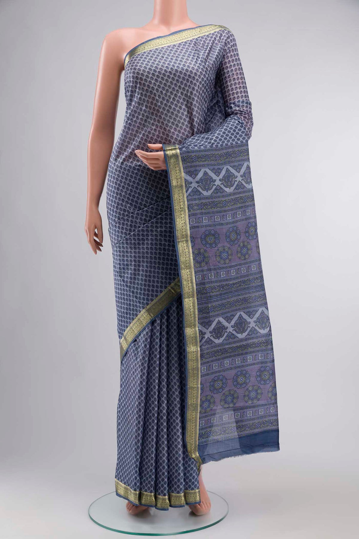Lilac Printed Silk Saree with Printed design on the body and Zari Border displayed on a mannequin