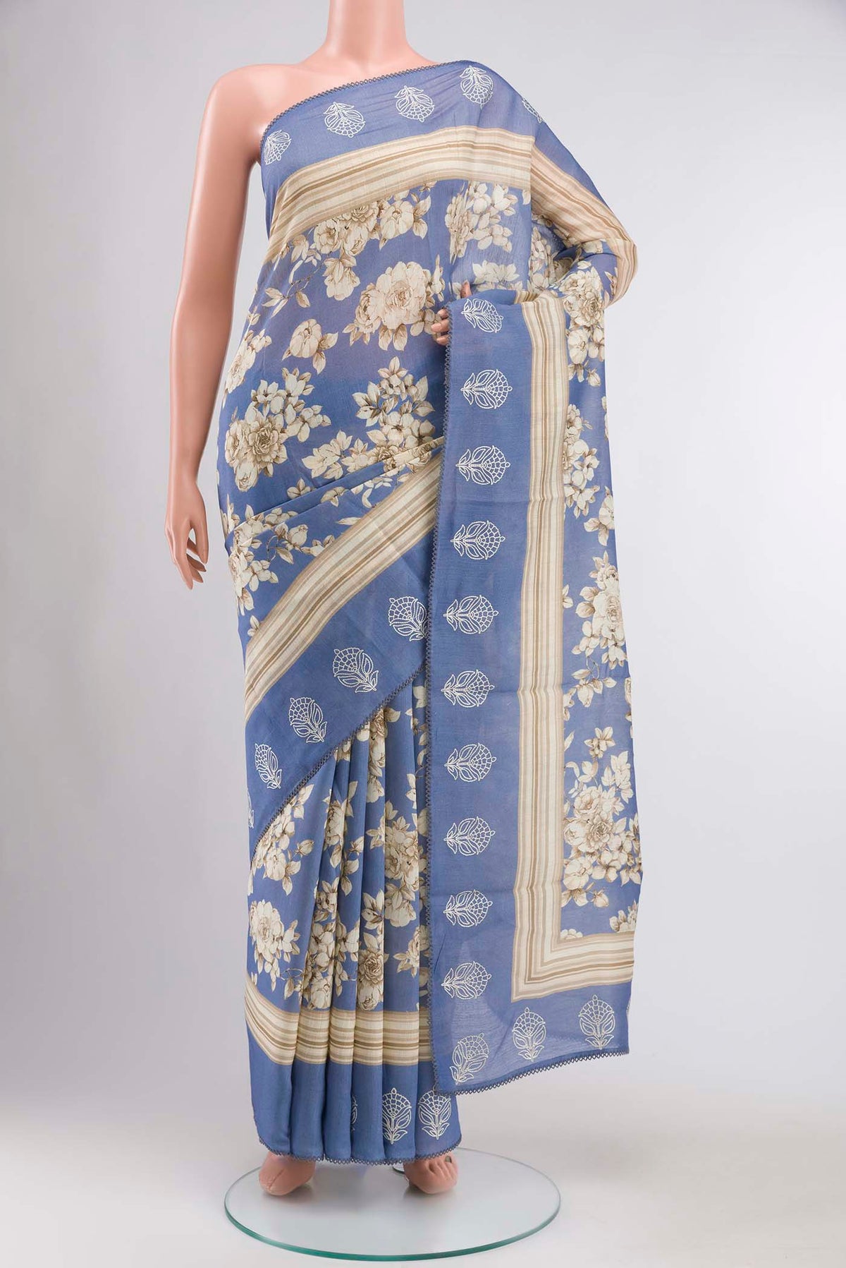 Blue Tussar Silk Saree with Printed design on the body and Embroidery Border displayed on a mannequin