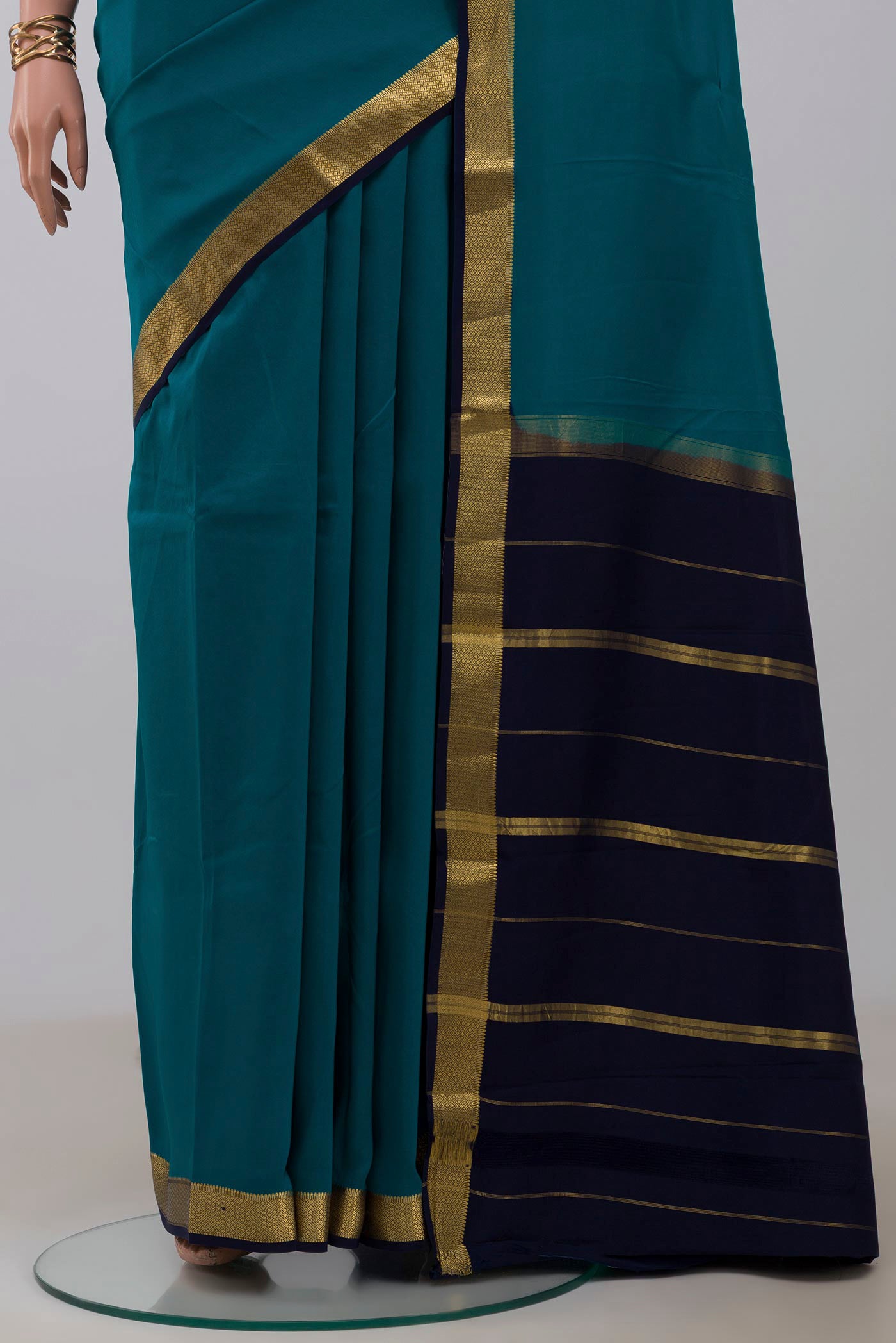 Pleats and pallu of Pure Silk Pure Zari Peacock Blue Mysore Silk Saree with Plain Body and Zari Border. 