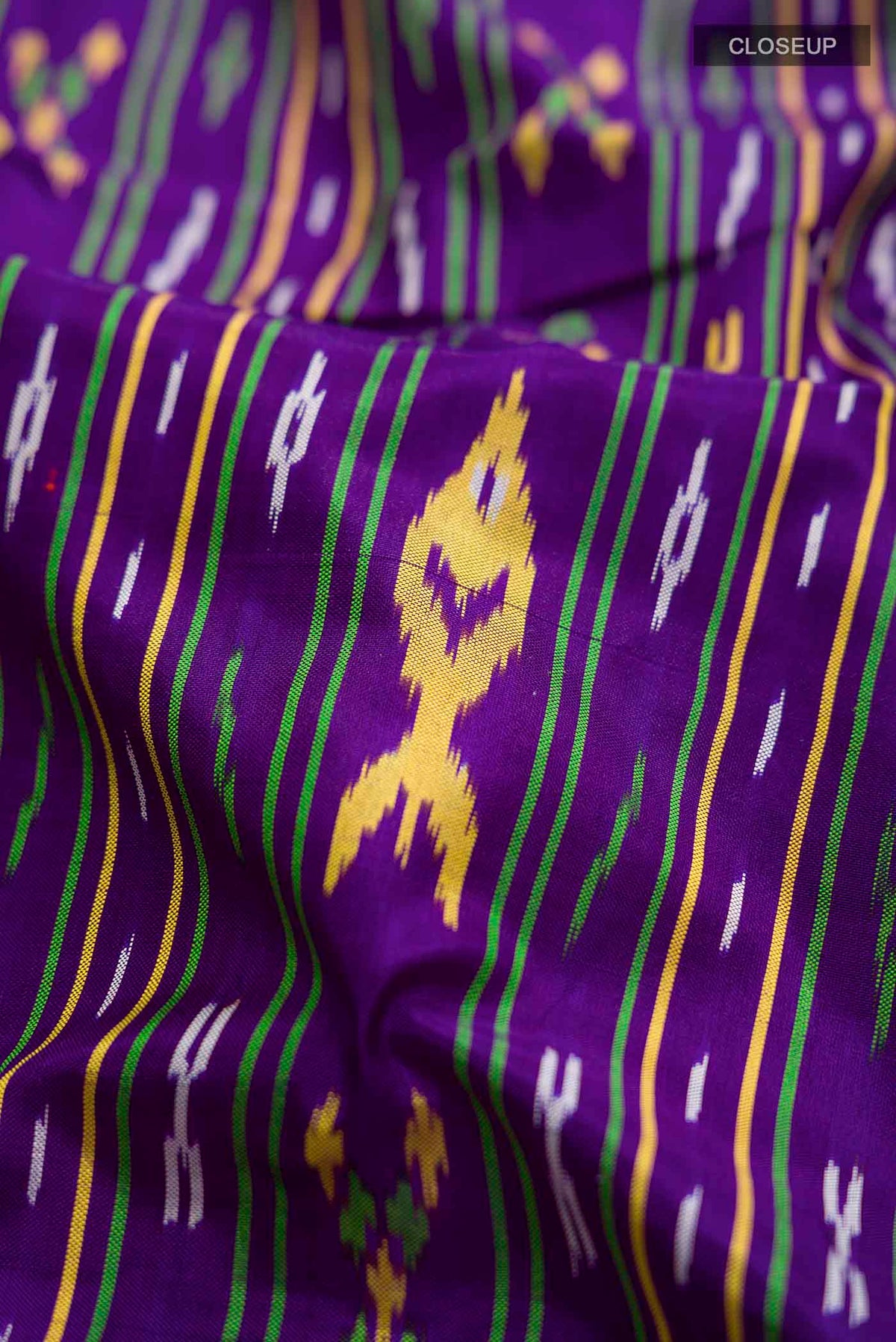 Close up of Violet Pochampally Silk Saree with Pure Ikat on the body and Plain Border displaying folds