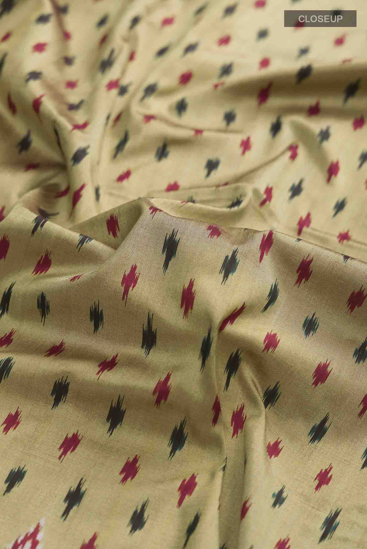 Close up of Green Pochampally Silk Saree with Pure Ikat on the body and Zari Border displaying folds