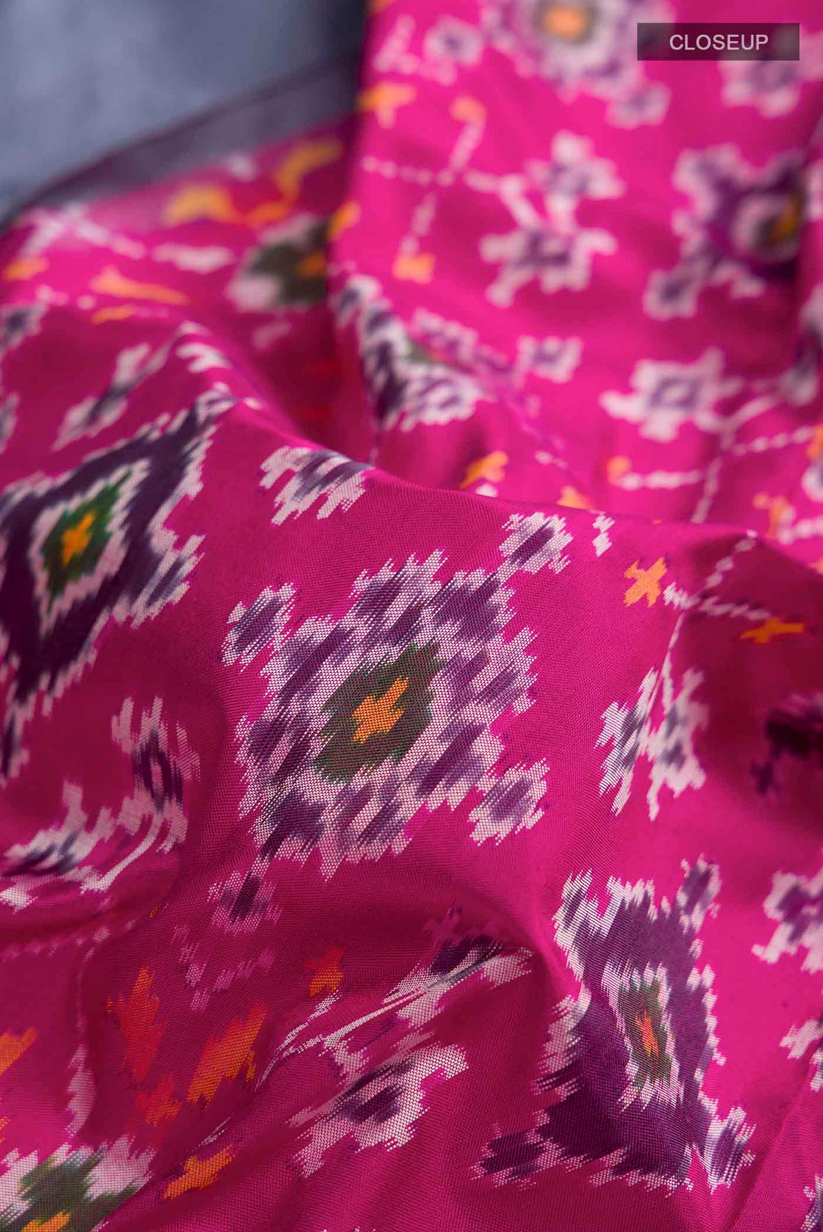 Close up of Pink Pochampally Silk Saree with Pure Ikat on the body and Zari Border displaying folds