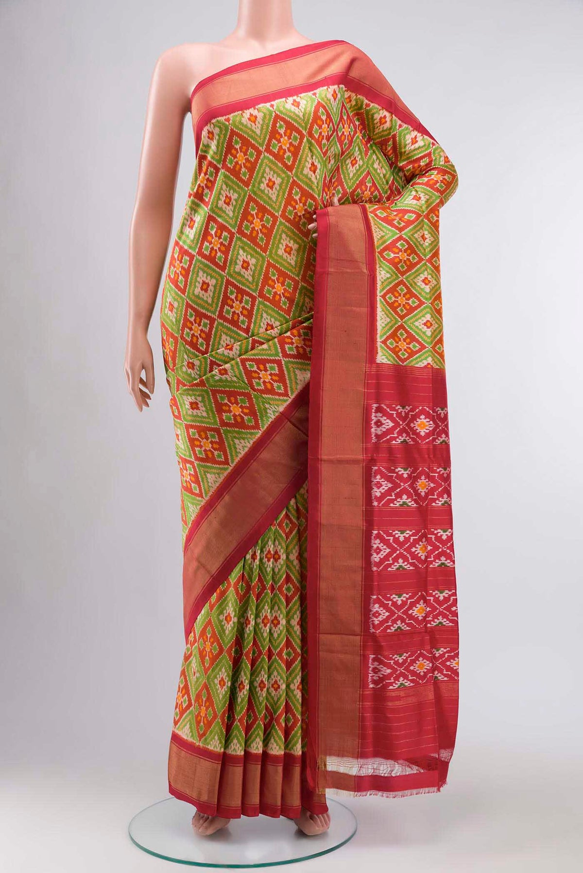 Rust Pochampally Silk Saree with Pure Ikat on the body and Zari Border displayed on a mannequin