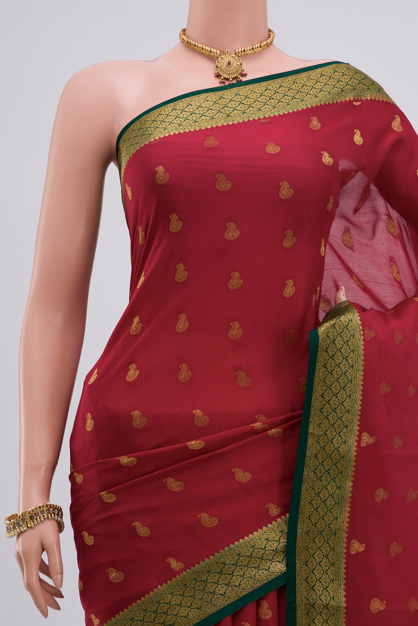 Border image of Red Crepe Saree with Zari Butta on the body and Zari Border. 