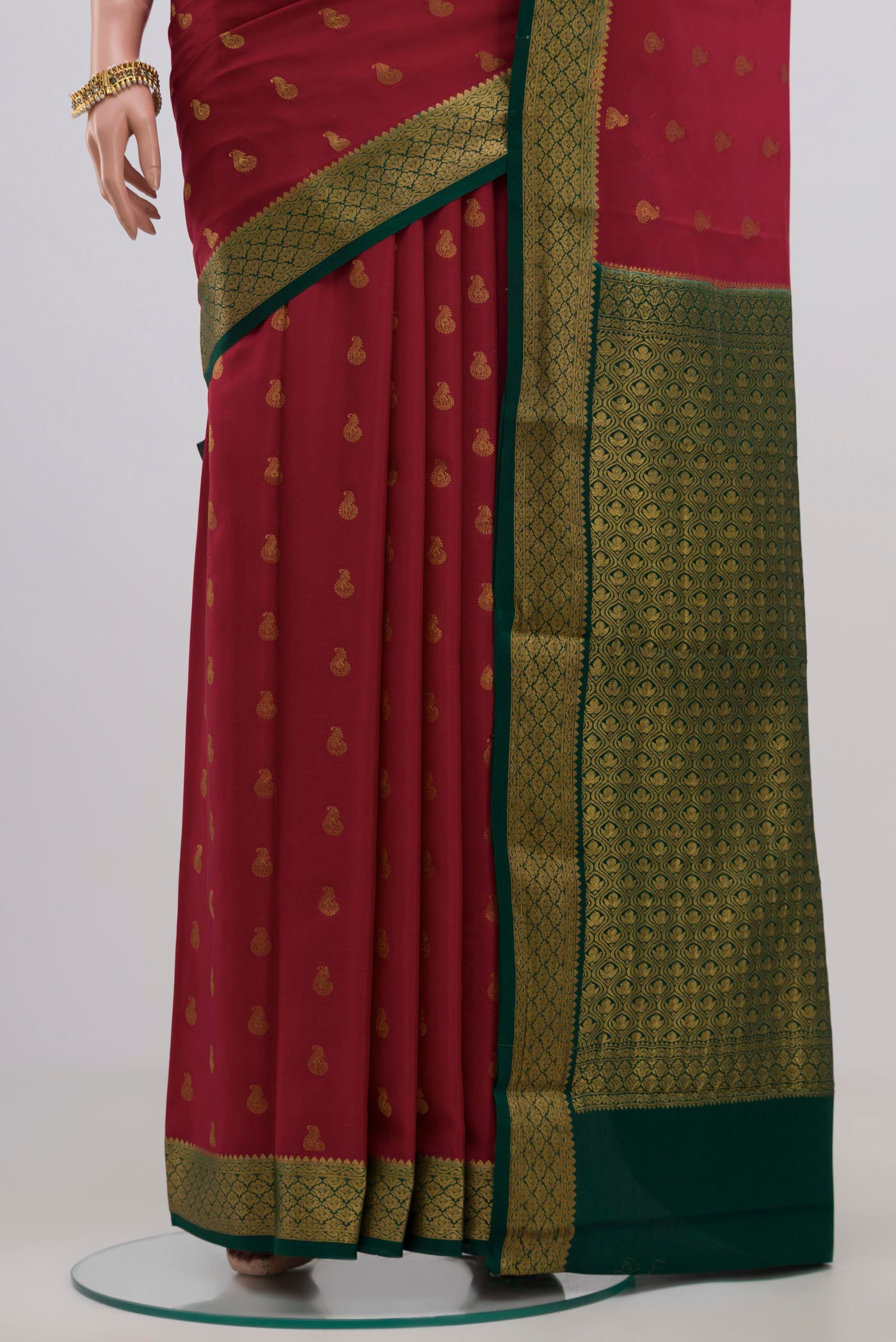 Pleats and pallu of Red Crepe Saree with Zari Butta on the body and Zari Border. 