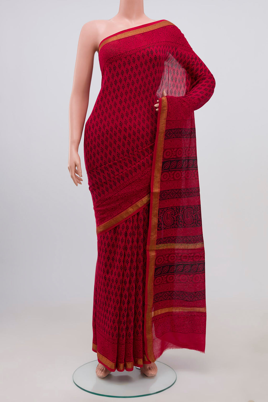 Red Maheshwari Silk Cotton Saree with Printed design on the body and Zari Border.  displayed on a mannequin