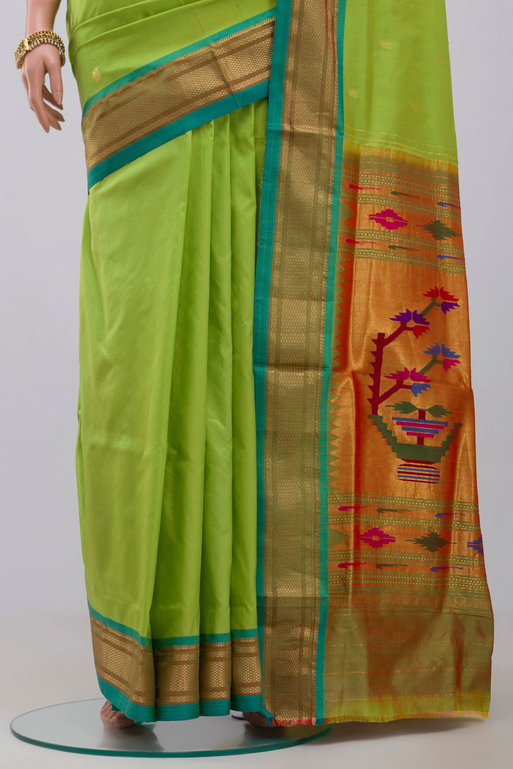 Pleats and pallu of Green Paithani Silk Saree with Zari Butta on the body and Zari Border. 