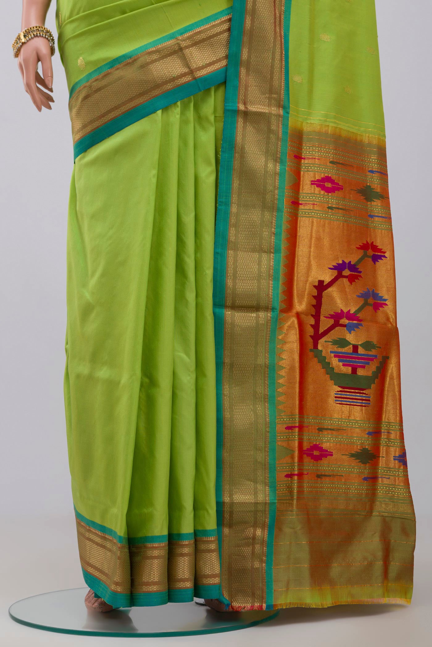 Pleats and pallu of Green Paithani Silk Saree with Zari Butta on the body and Zari Border. 