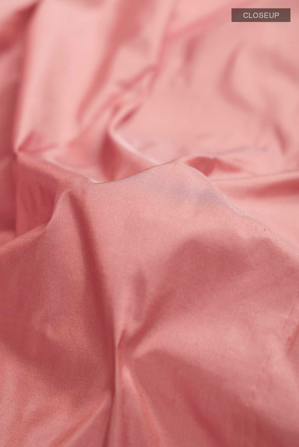 Close up of Peach Bangalore Silk Saree with Plain Body and Zari Border displaying folds