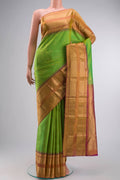 Green Kanchipuram Silk Saree with Zari Butta on the body and Zari Border displayed on a mannequin