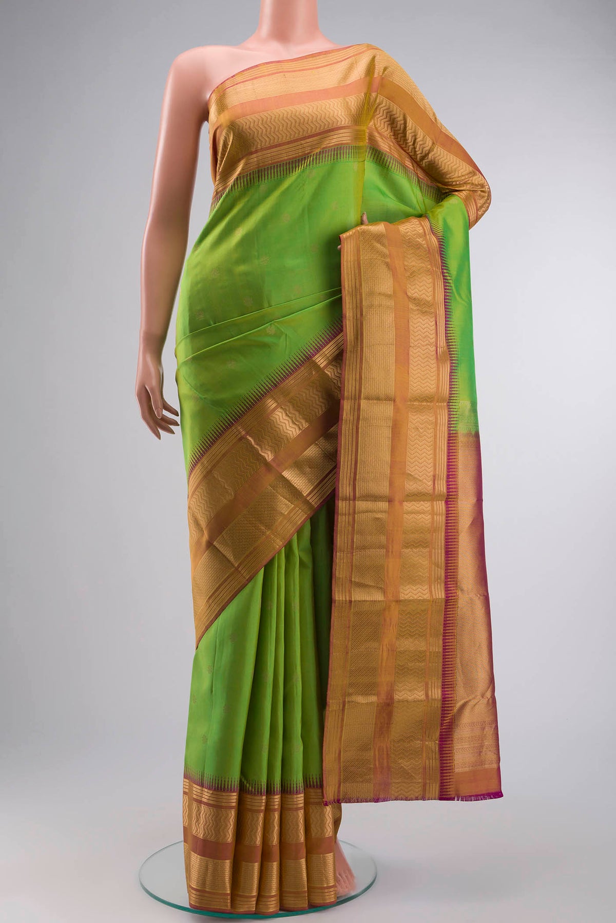 Green Kanchipuram Silk Saree with Zari Butta on the body and Zari Border displayed on a mannequin