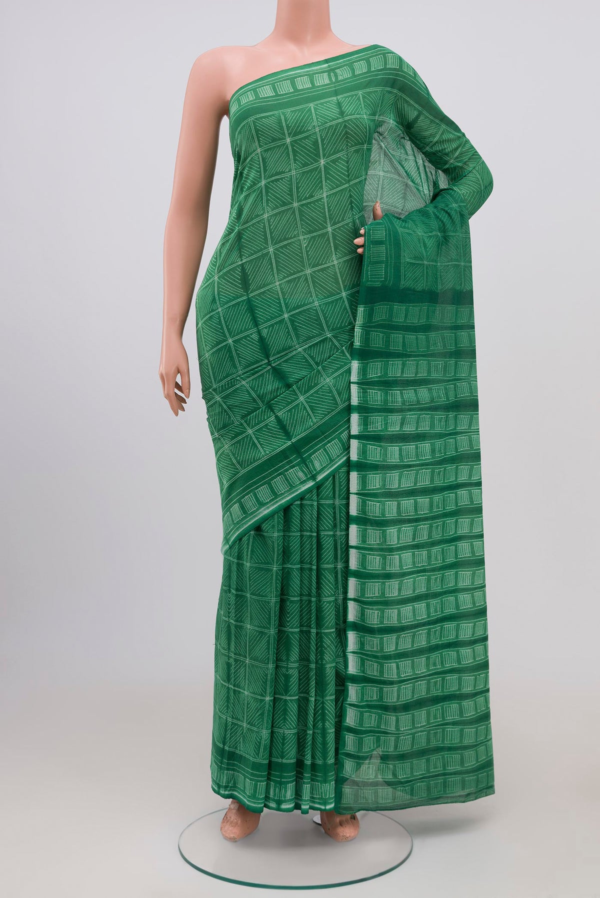 Light Green Printed Cotton Saree with Printed design on the body and Printed Border.  displayed on a mannequin