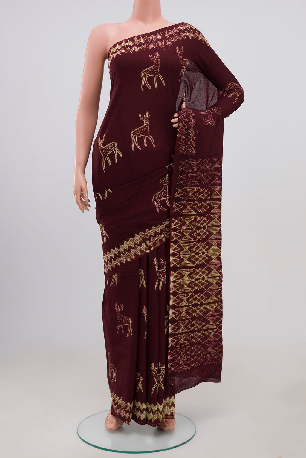 Brown Printed Cotton Saree with Printed design on the body and Without Border.  displayed on a mannequin