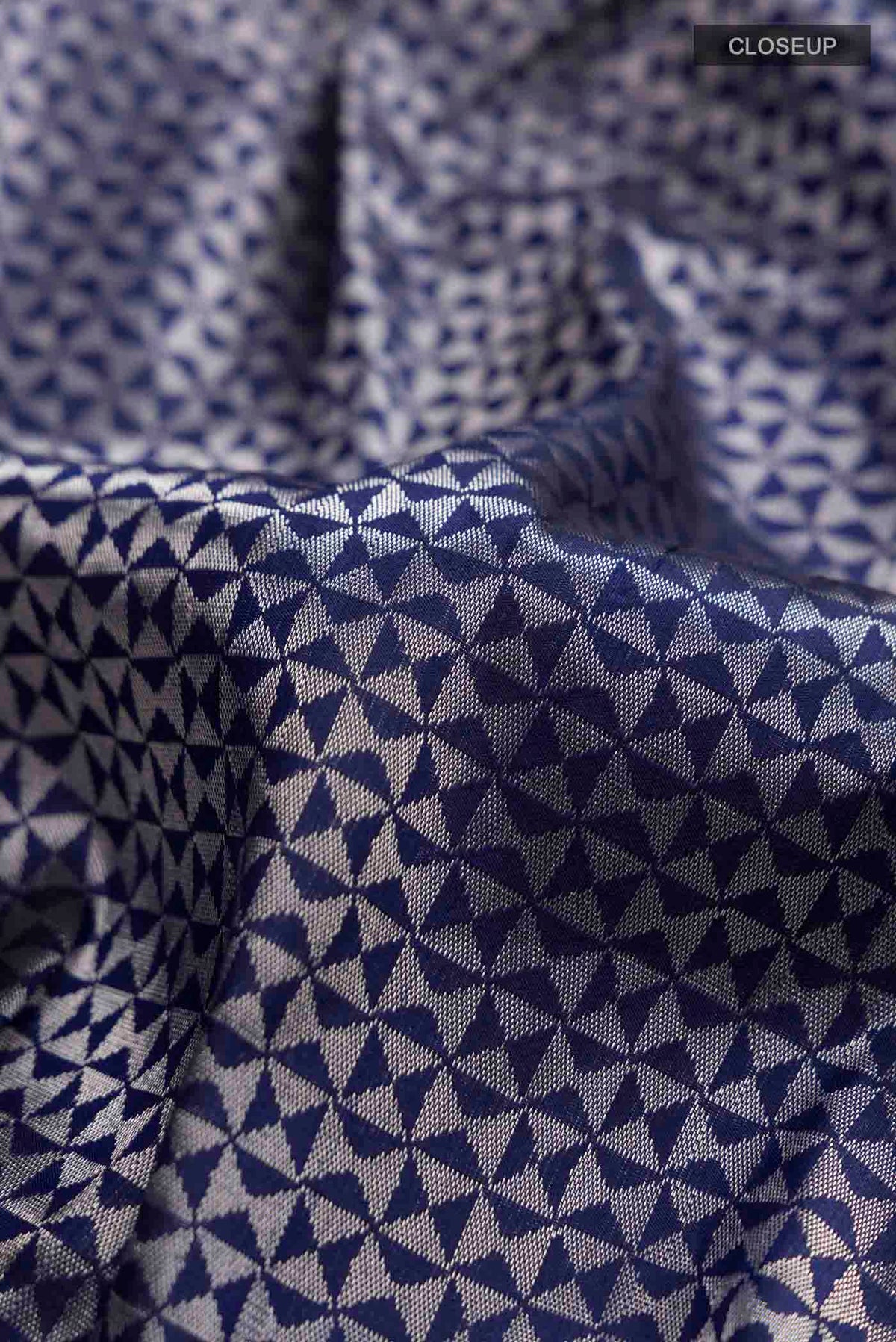 Close up of Navy Blue Banarasi Katan Silk Saree with Zari Butta on the body and Zari Border displaying folds