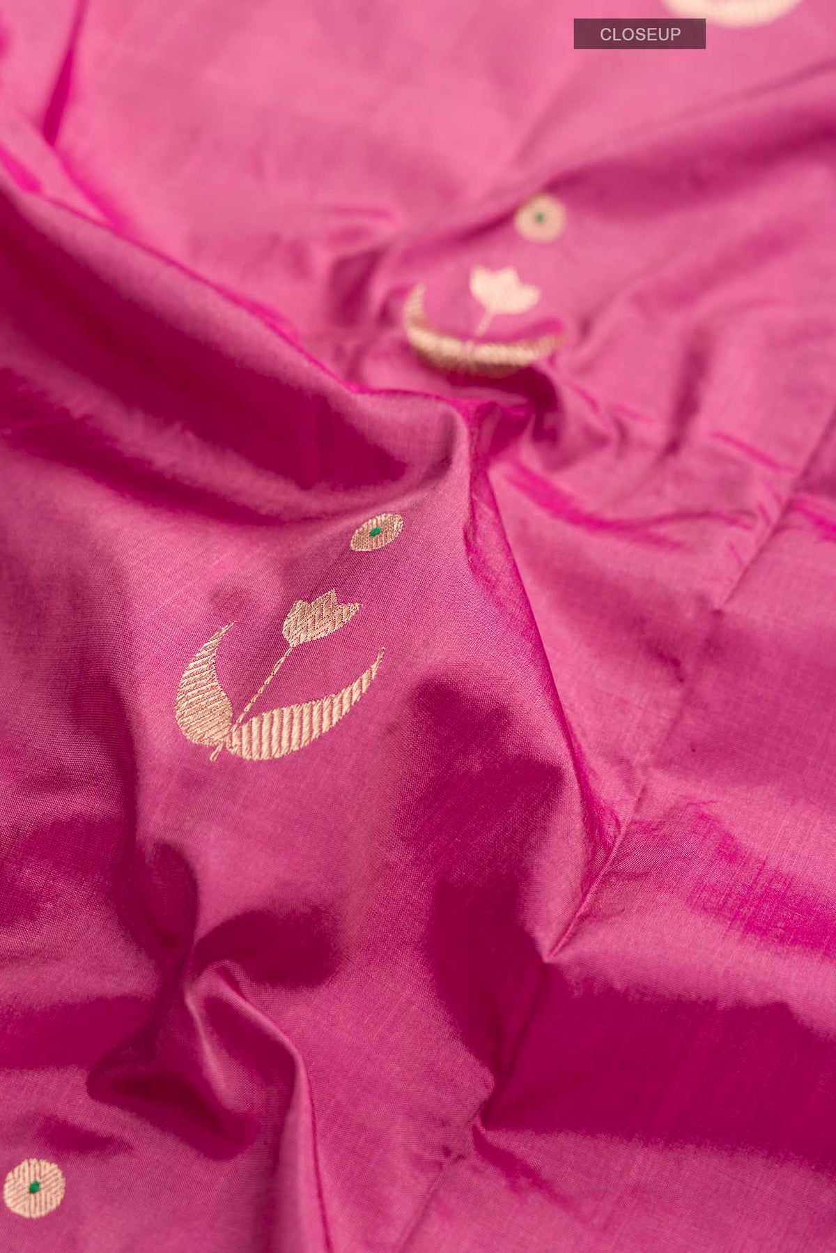 Close up of Pink Banarasi Katan Silk Saree with Zari Butta on the body and Plain Border displaying folds