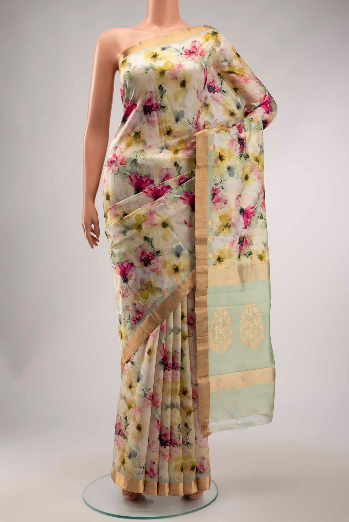 Green Tussar Silk Saree with Printed design on the body and Zari Border displayed on a mannequin