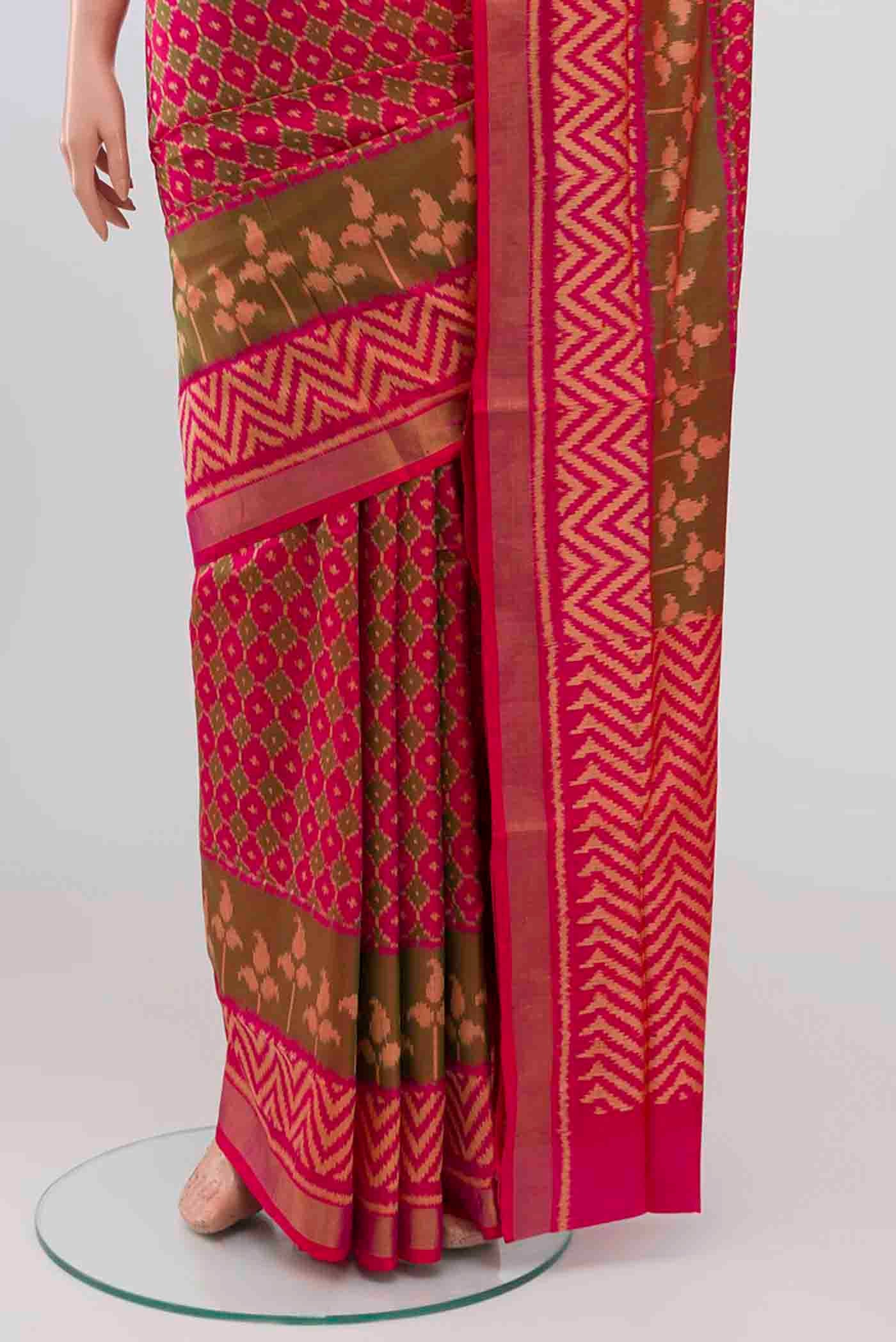 Pleats and pallu of Dark Pink Rajkot Patola Silk Saree with Ikat design on the body and Zari Border. 
