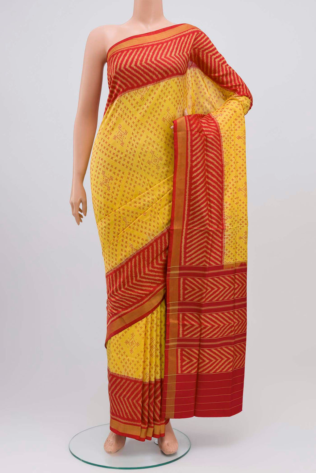Yellow Rajkot Patola Silk Saree with Ikat design on the body and Zari Border displayed on a mannequin