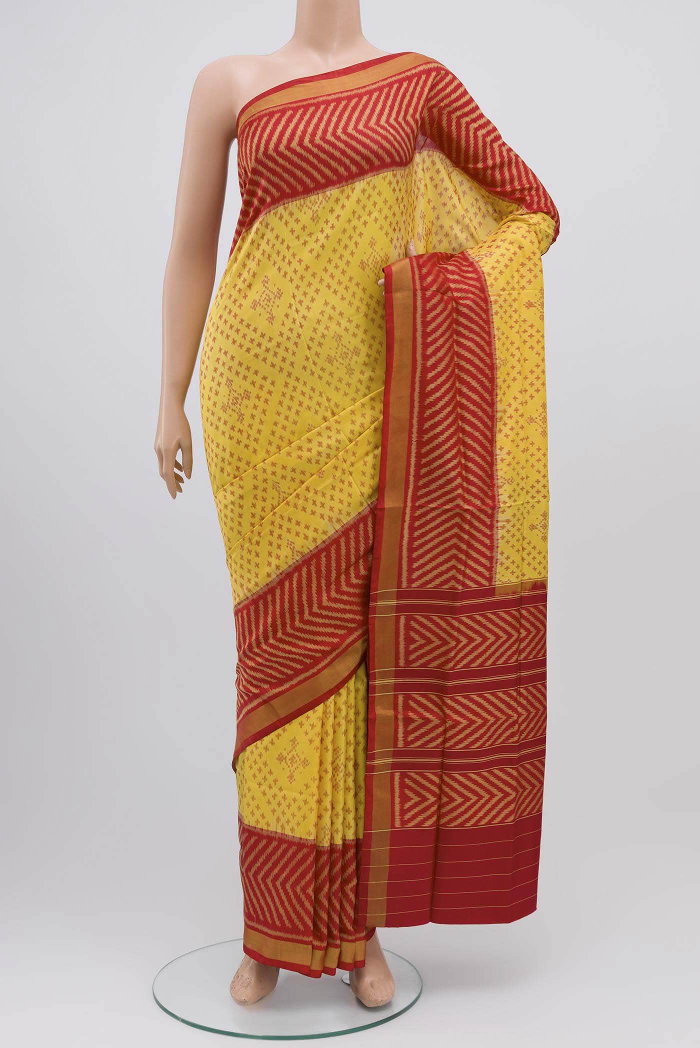 Yellow Rajkot Patola Silk Saree with Ikat design on the body and Zari Border displayed on a mannequin