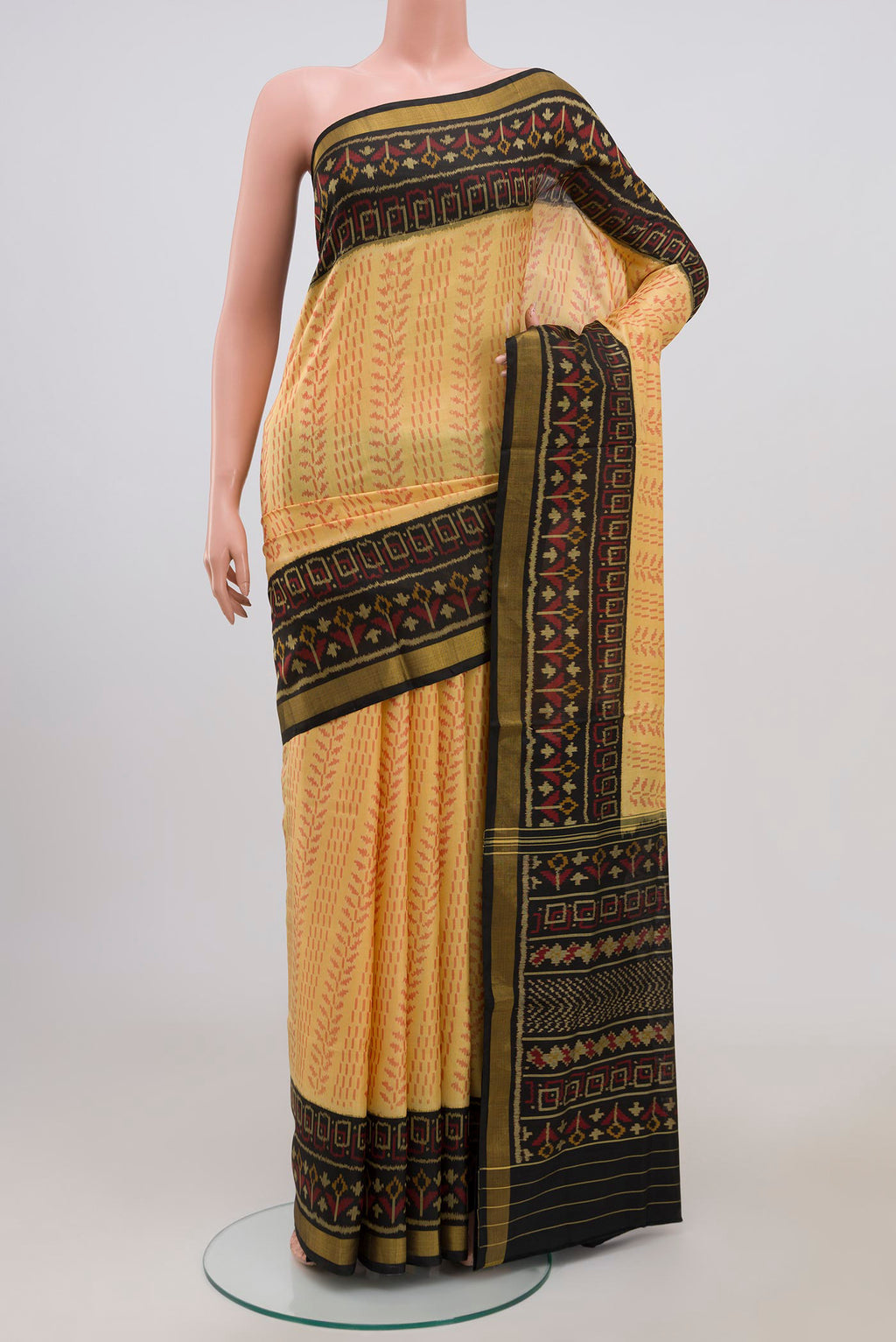 Cream Rajkot Patola Silk Saree with Ikat Print on the body and Ikat Border.  displayed on a mannequin