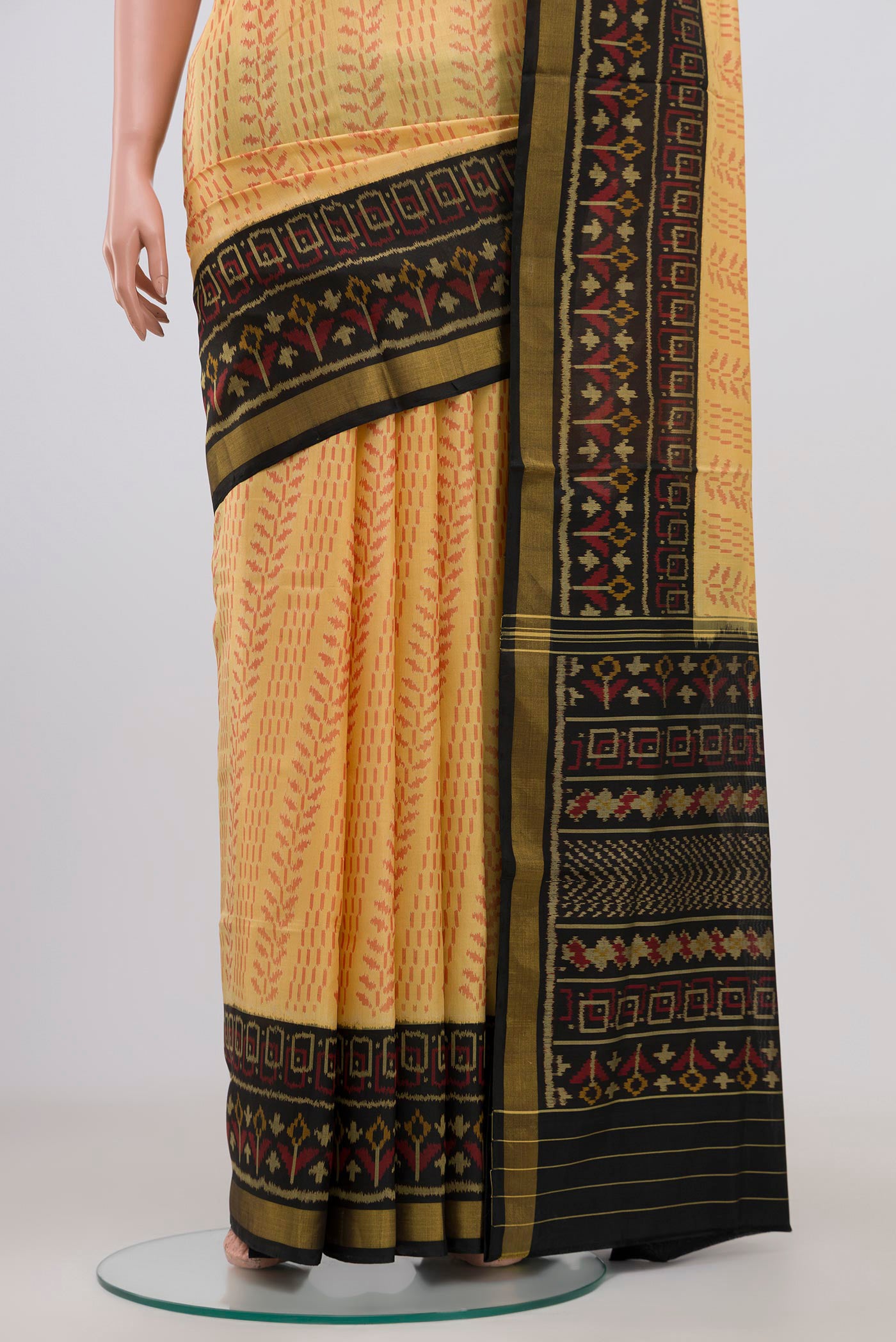 Pleats and pallu of Cream Rajkot Patola Silk Saree with Ikat Print on the body and Ikat Border. 