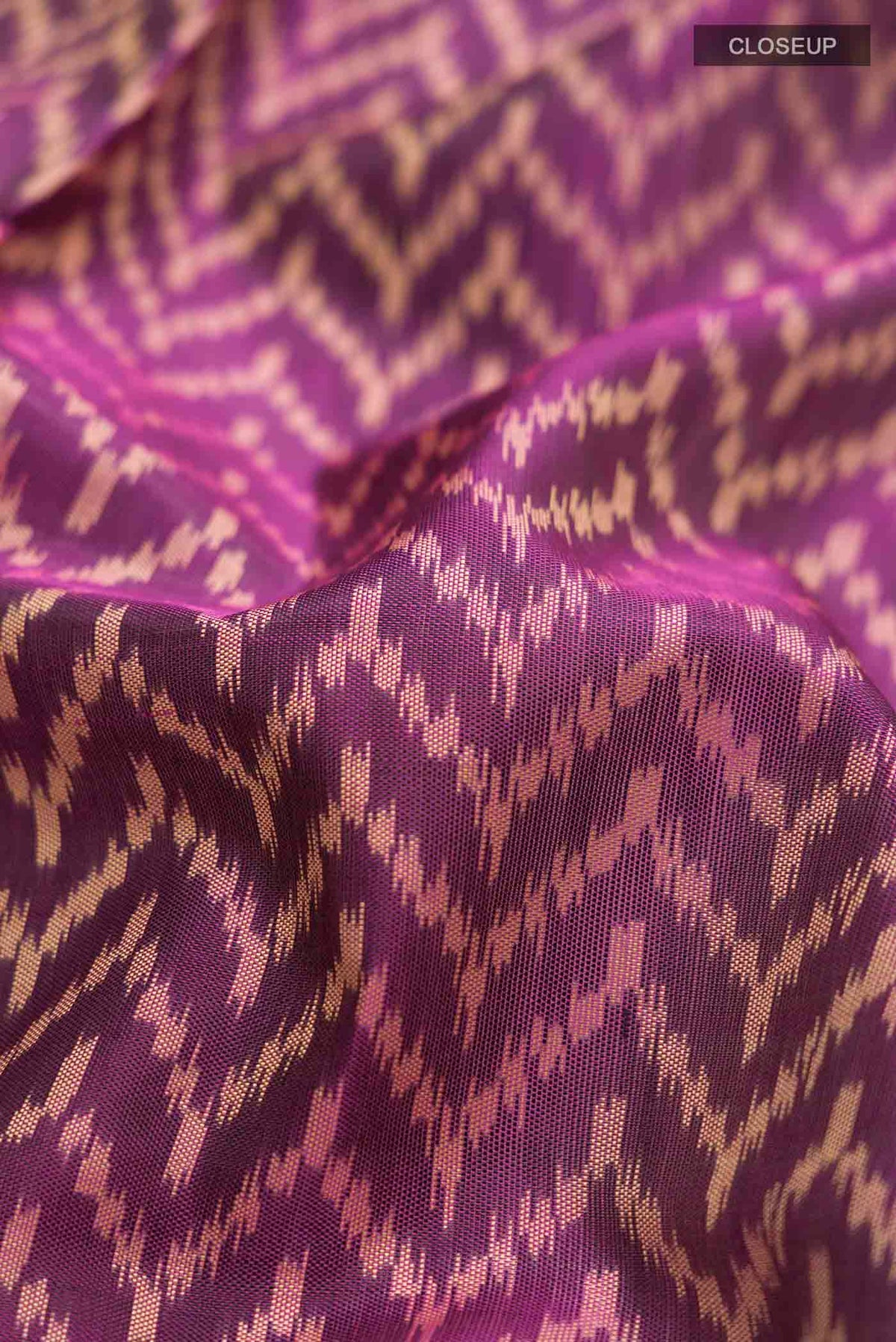 Close up of Violet Rajkot Patola Silk Saree with Pure Ikat on the body and Plain Border displaying folds