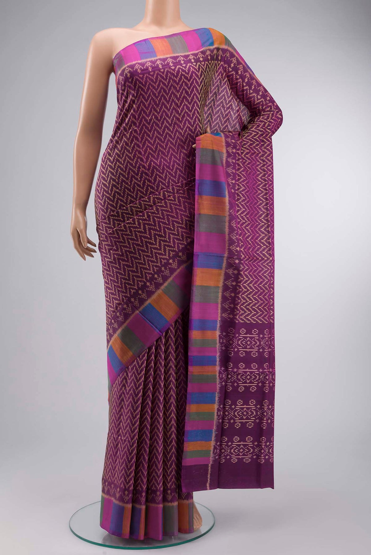 Violet Rajkot Patola Silk Saree with Pure Ikat on the body and Plain Border displayed on a mannequin