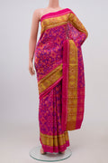 Pink Rajkot Patola Silk Saree with Ikat Print on the body and Ikat Border.  displayed on a mannequin