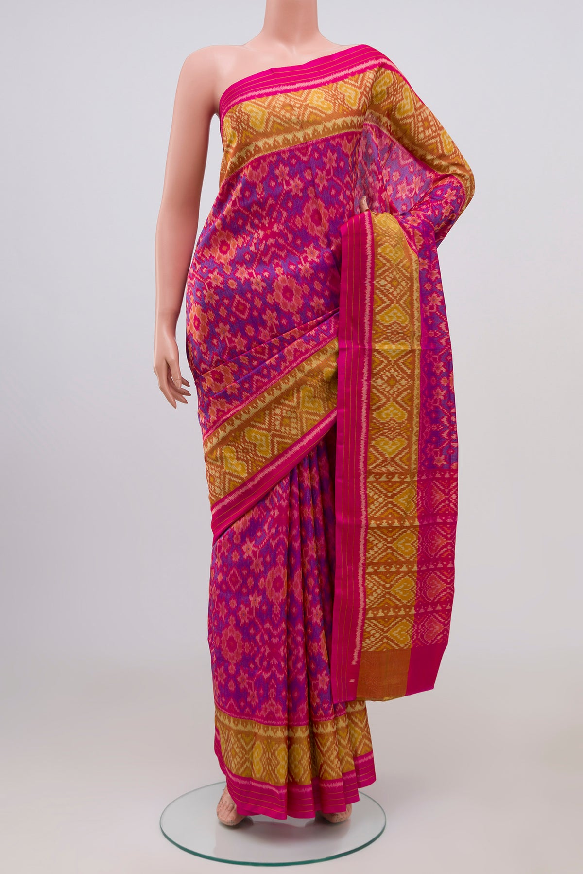 Pink Rajkot Patola Silk Saree with Ikat Print on the body and Ikat Border.  displayed on a mannequin