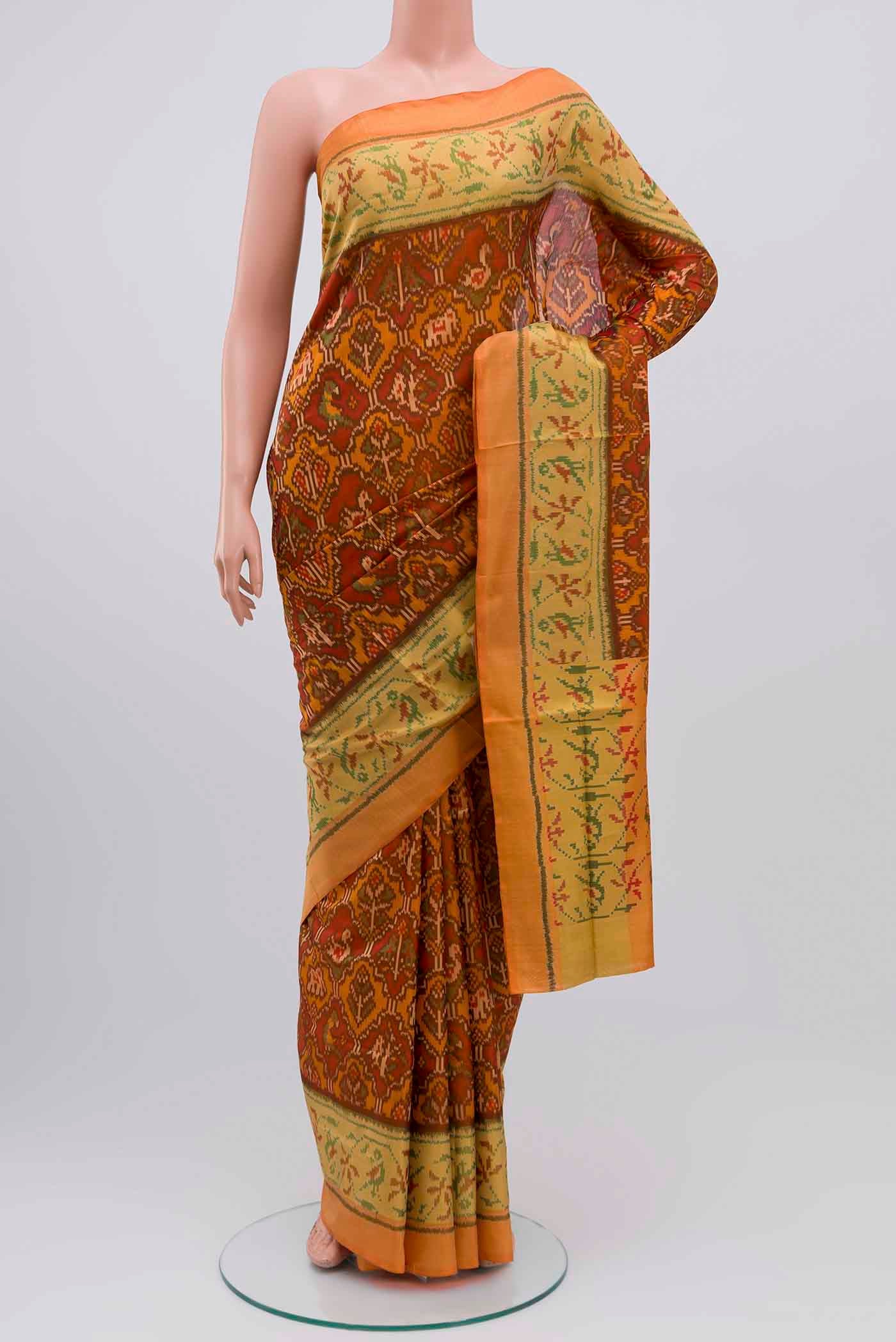 Rust Rajkot Patola Silk Saree with Pure Ikat on the body and Zari Border displayed on a mannequin