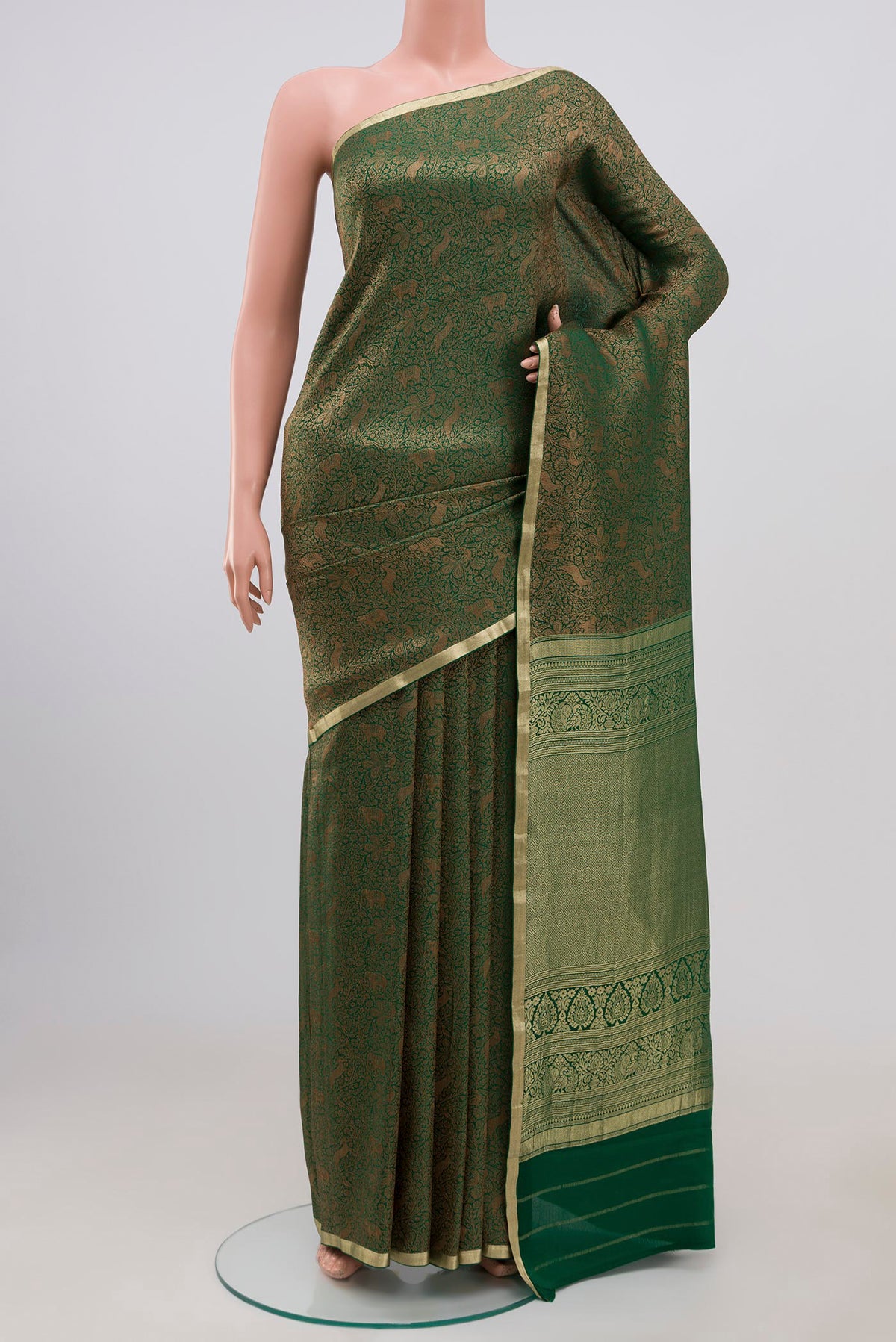 Green Mysore Crepe Saree with Zari Brocade on the body and Fancy Border.  displayed on a mannequin