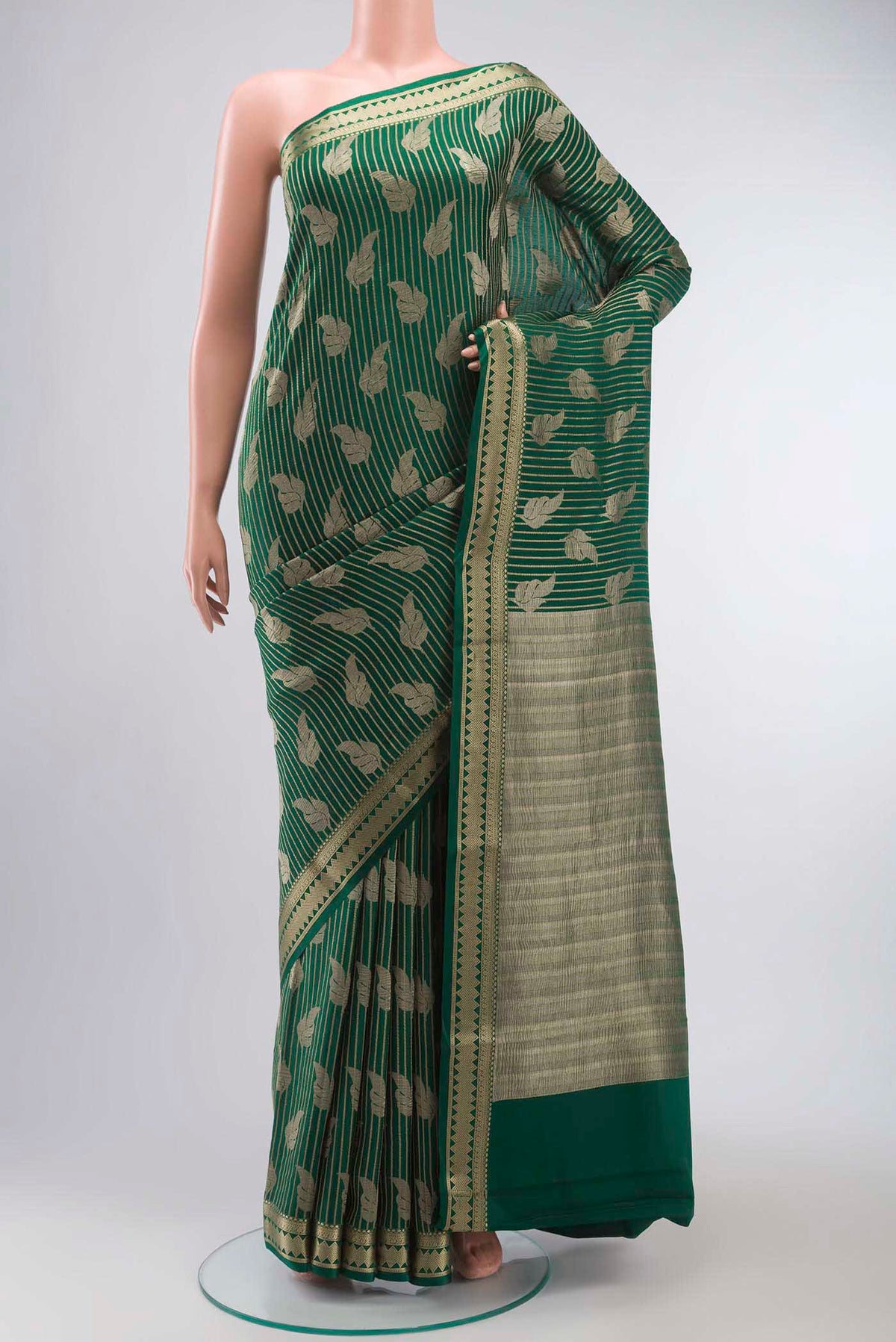 Green Mysore Crepe Saree with Zari Butta on the body and Zari Border displayed on a mannequin
