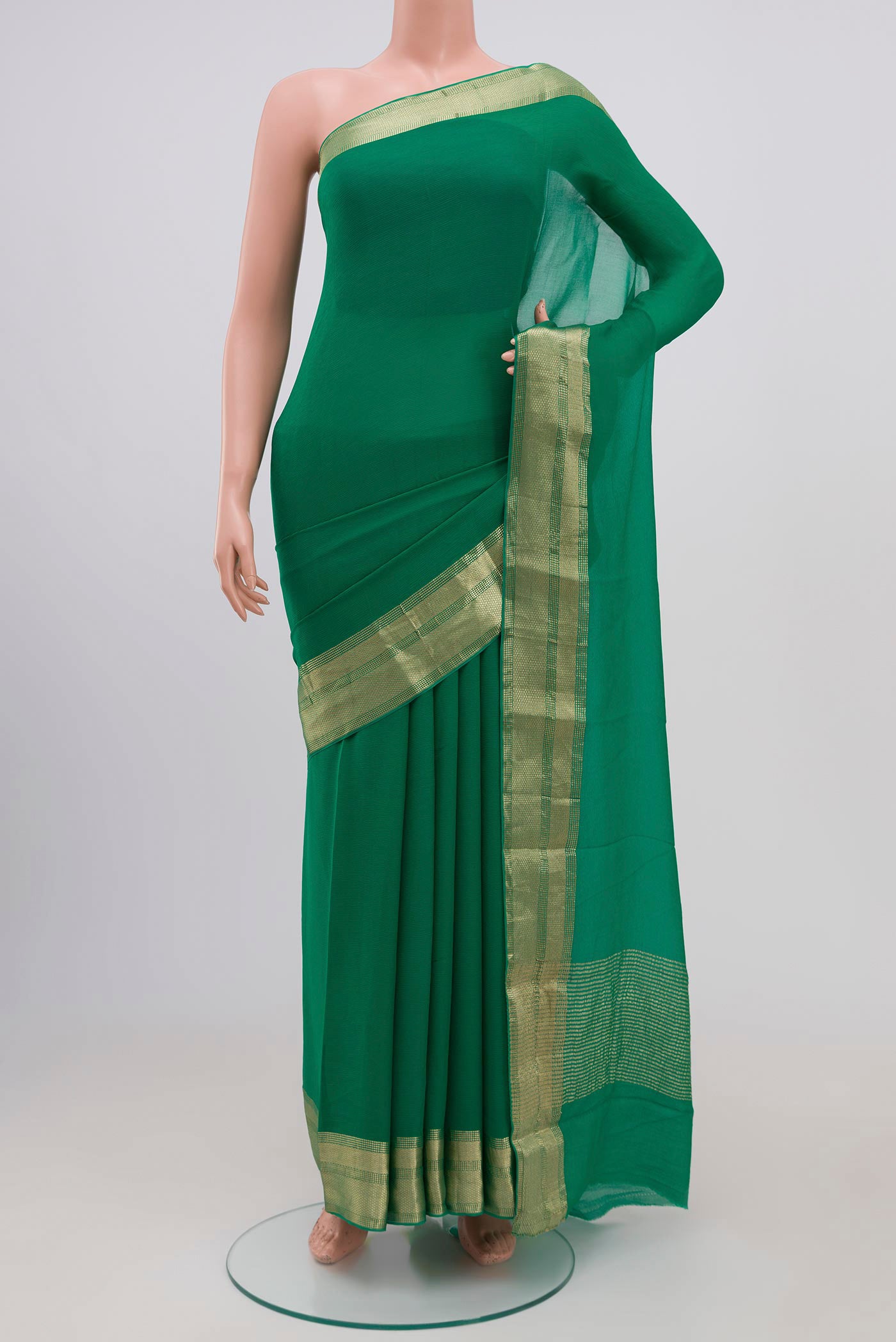 Green Chiffon Saree with Plain Body and Attached Border.  displayed on a mannequin