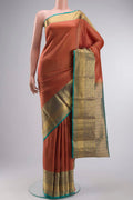 Rust Kanchipuram Silk Saree with Zari Brocade on the body and Zari Border displayed on a mannequin