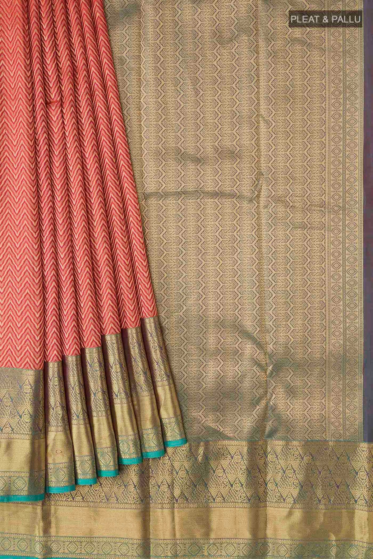 Pleats and pallu of Rust Kanchipuram Silk Saree with Zari Brocade on the body and Zari Border