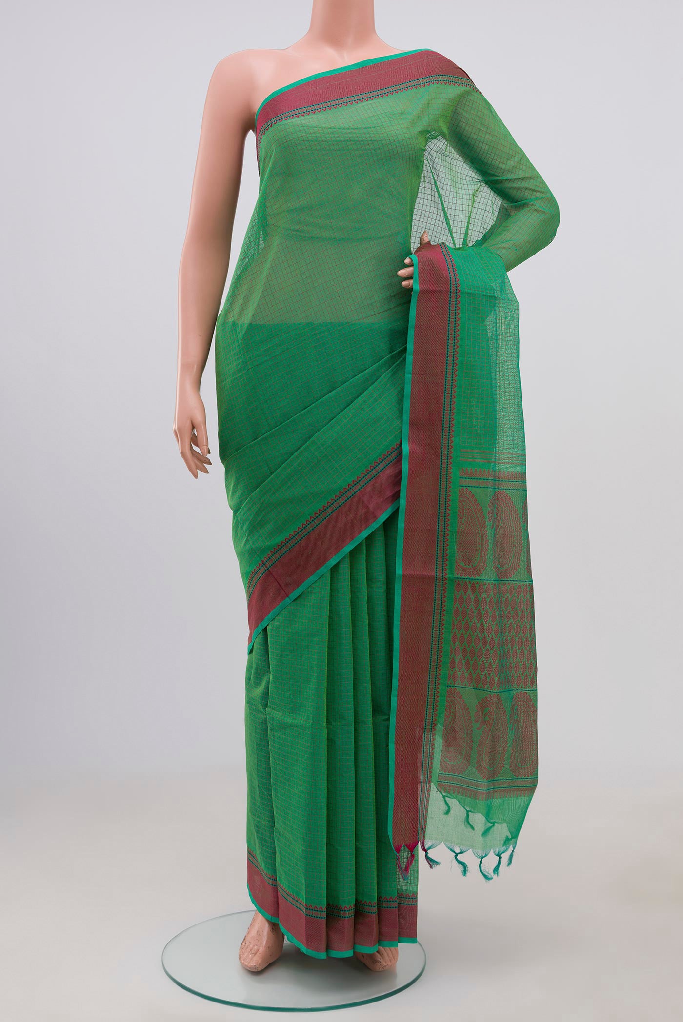 Green Coimbatore Cotton Saree with Checked design on the body and Thread Border.  displayed on a mannequin