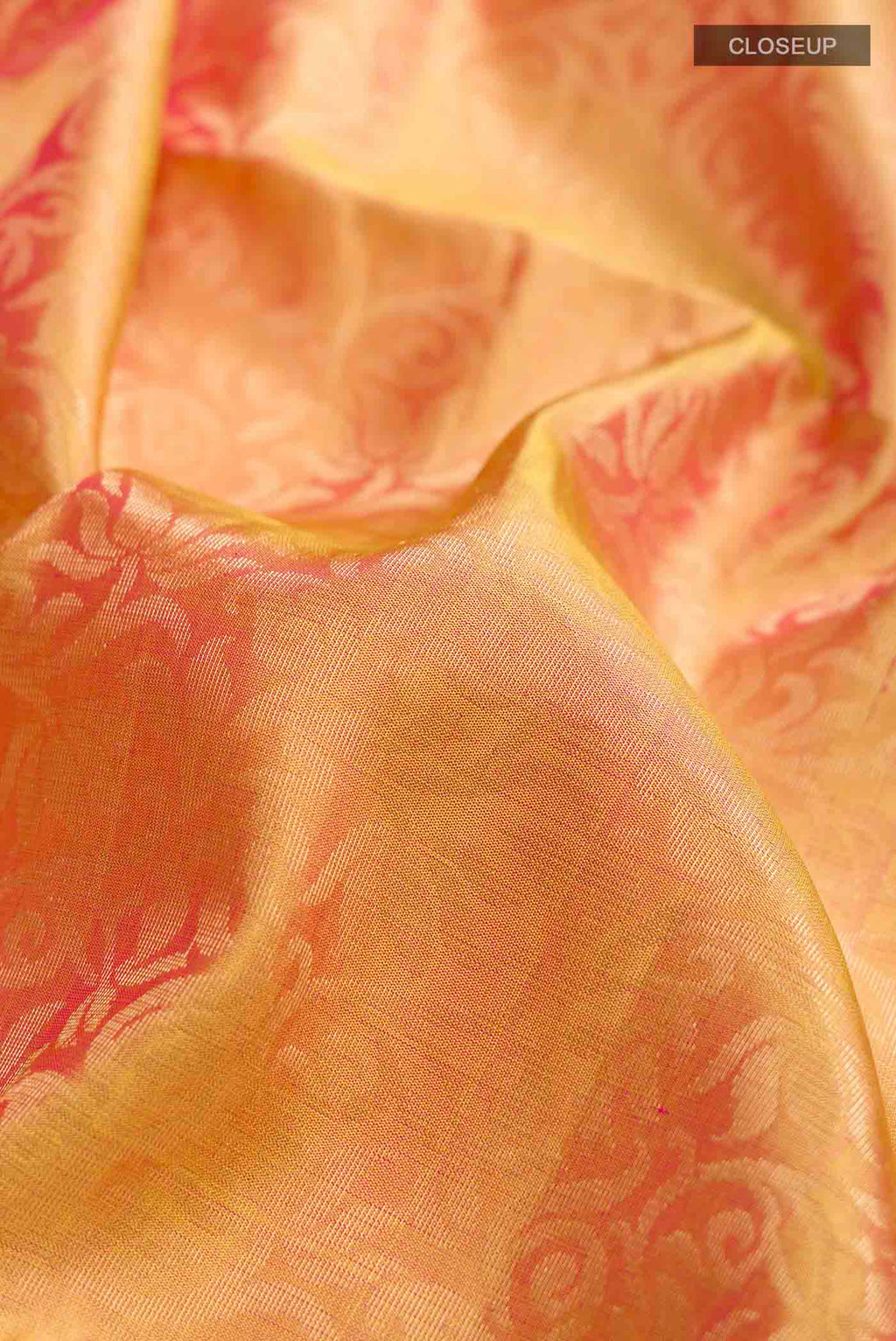Close up of Yellow with Pink Color Soft Silk Saree with Zari Brocade on the body and Zari Border displaying folds