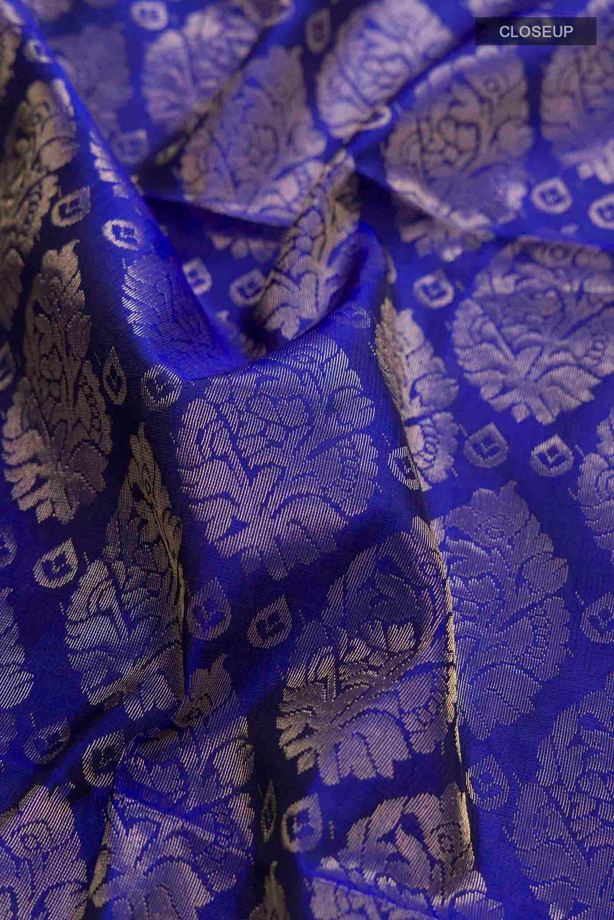 Close up of Blue Soft Silk Saree with Zari Brocade on the body and Zari Border displaying folds