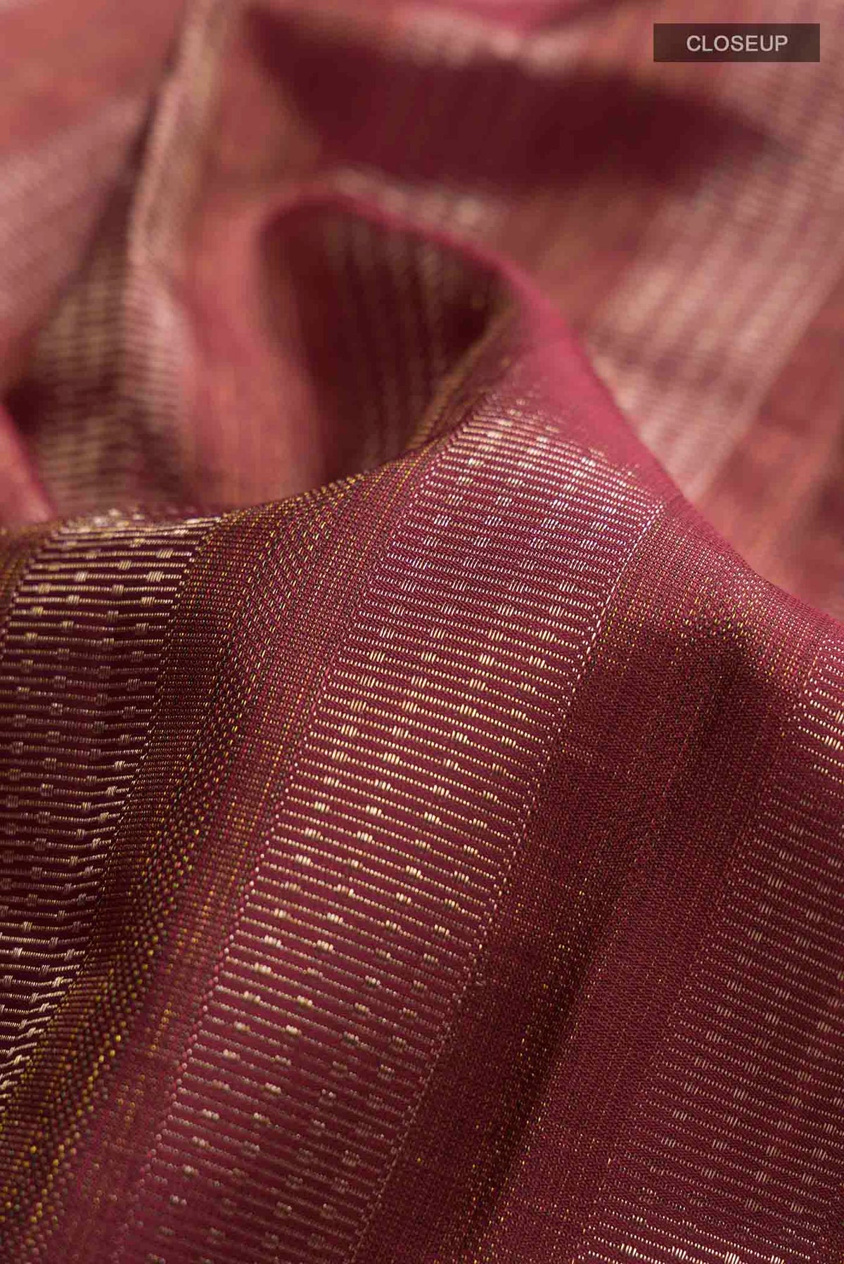 Close up of Maroon Kanchipuram Silk Saree with Zari Brocade on the body and Zari Border displaying folds