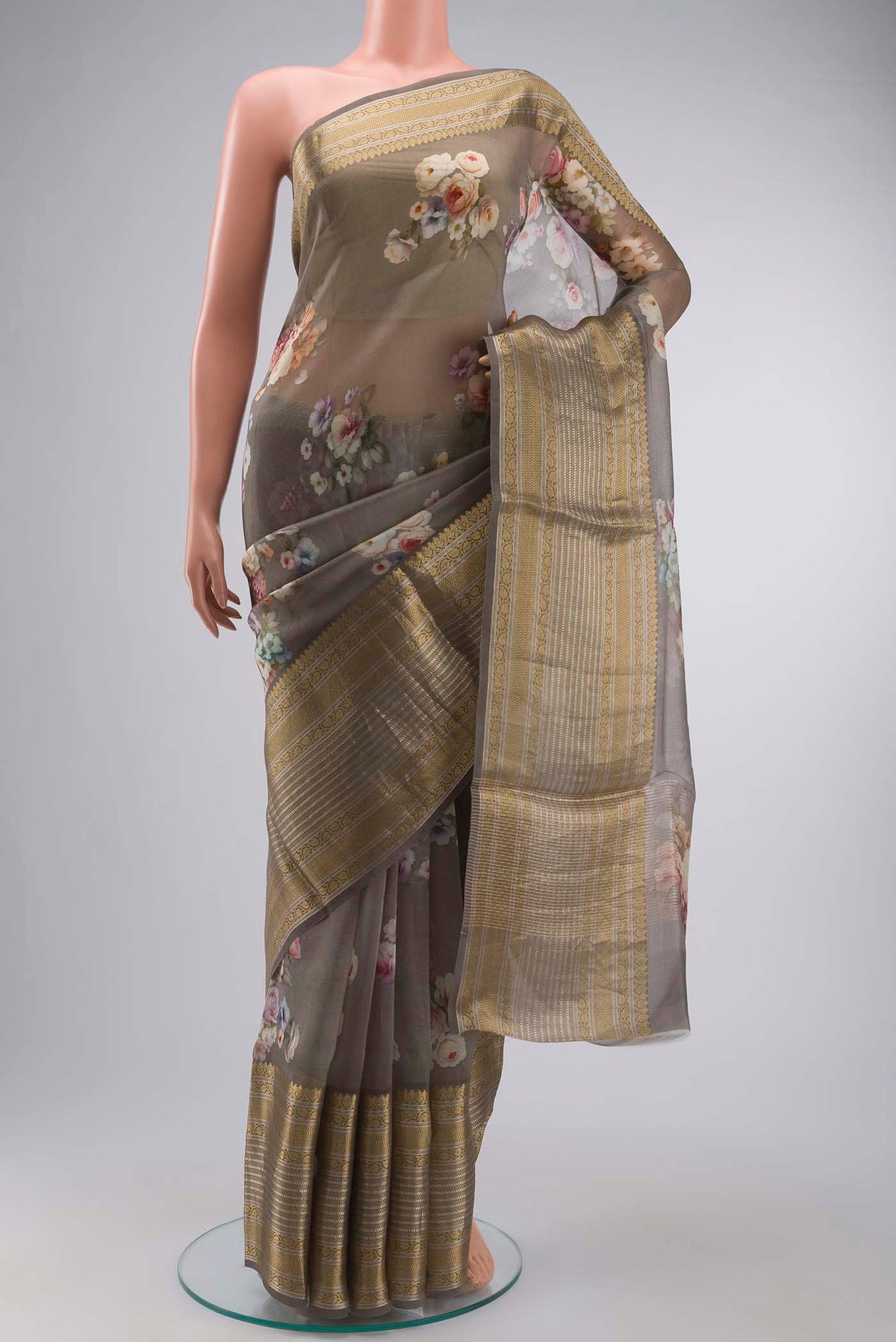 Grey Organza Silk Saree with Printed design on the body and Zari Border displayed on a mannequin