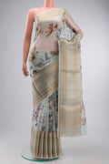 Light Blue Organza Silk Saree with Printed design on the body and Zari Border displayed on a mannequin