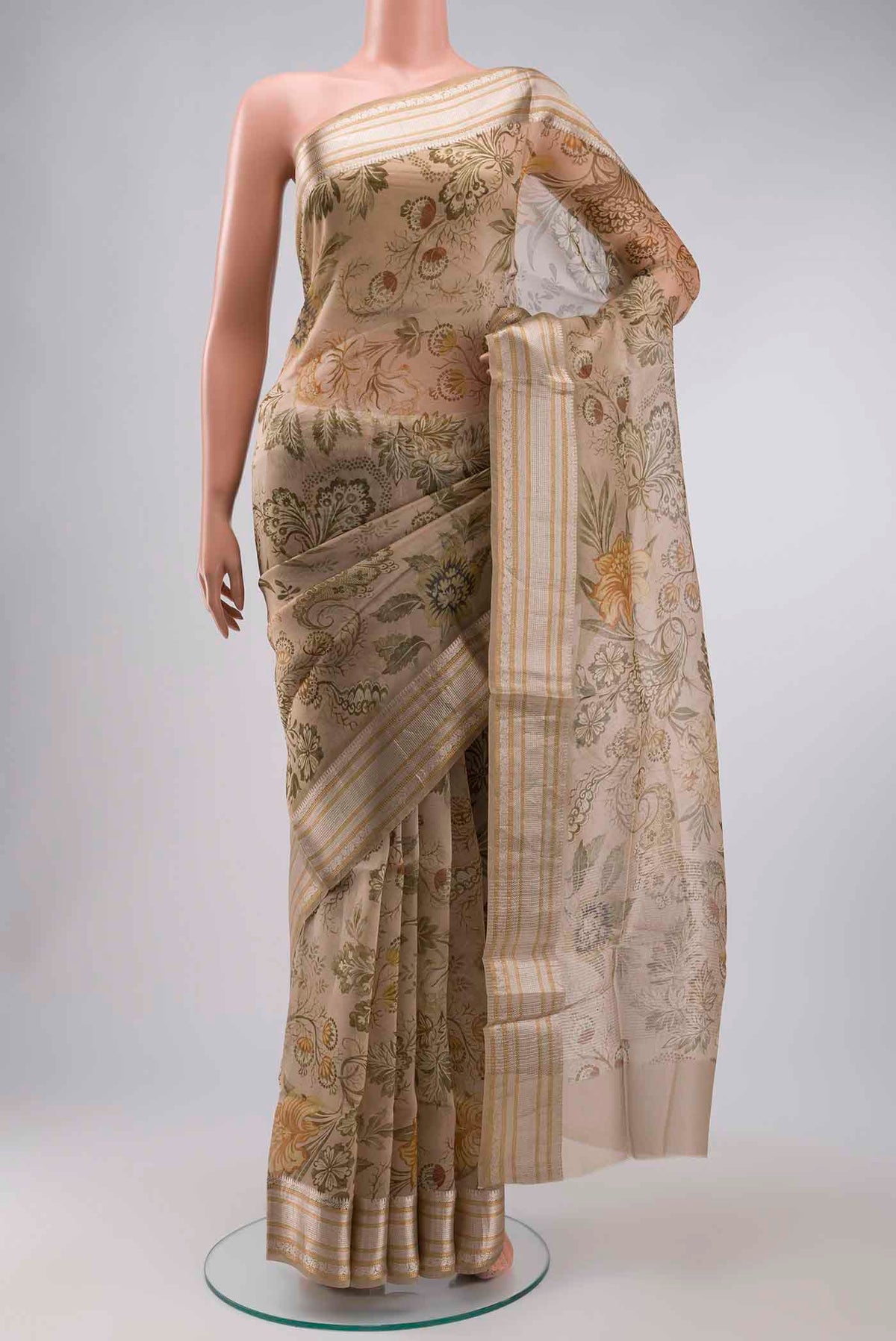 Beige Organza Silk Saree with Floral Print on the body and Zari Border displayed on a mannequin