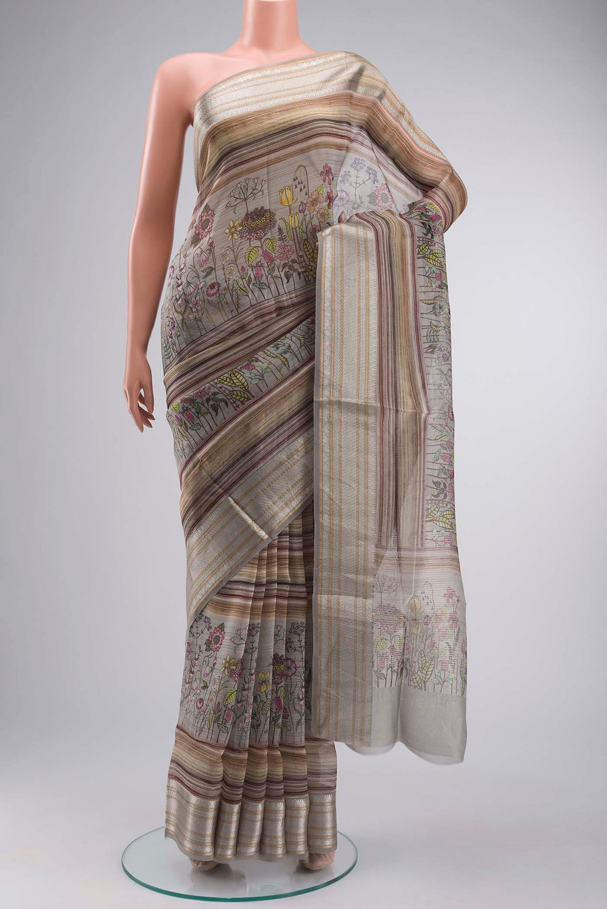 Grey Organza Silk Saree with Printed design on the body and Zari Border displayed on a mannequin