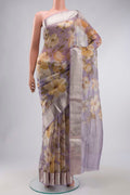 Lavender Organza Silk Saree with Printed design on the body and Zari Border displayed on a mannequin