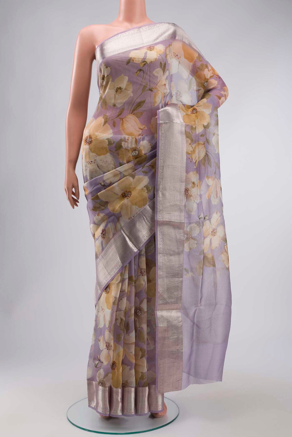 Lavender Organza Silk Saree with Printed design on the body and Zari Border displayed on a mannequin