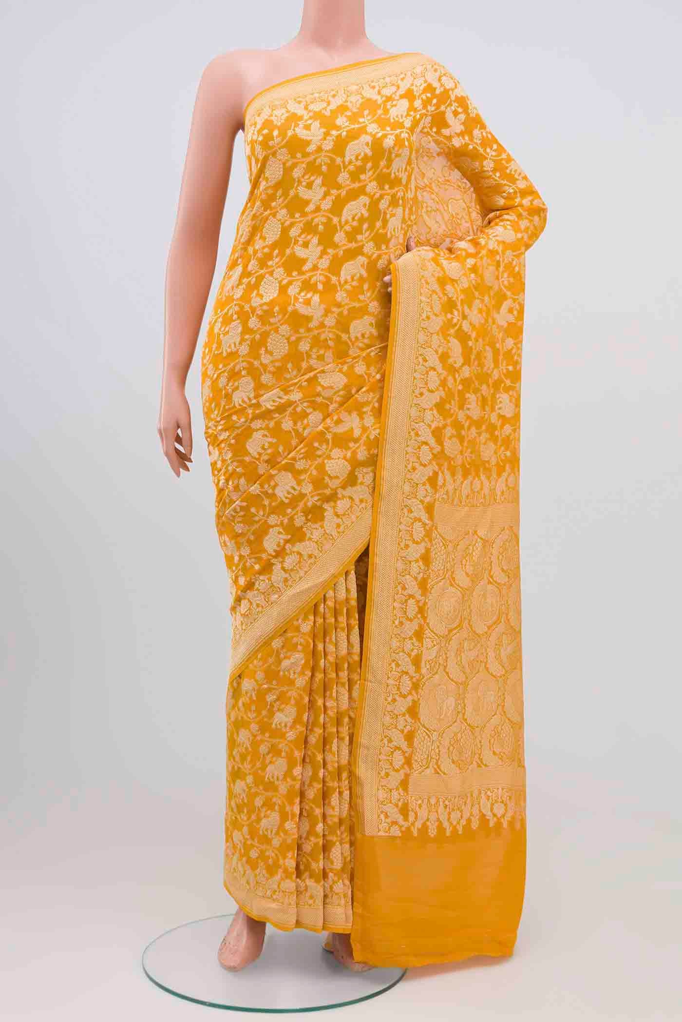 Yellow Banarasi Georgette Saree with Zari Brocade on the body and Zari Border.  displayed on a mannequin
