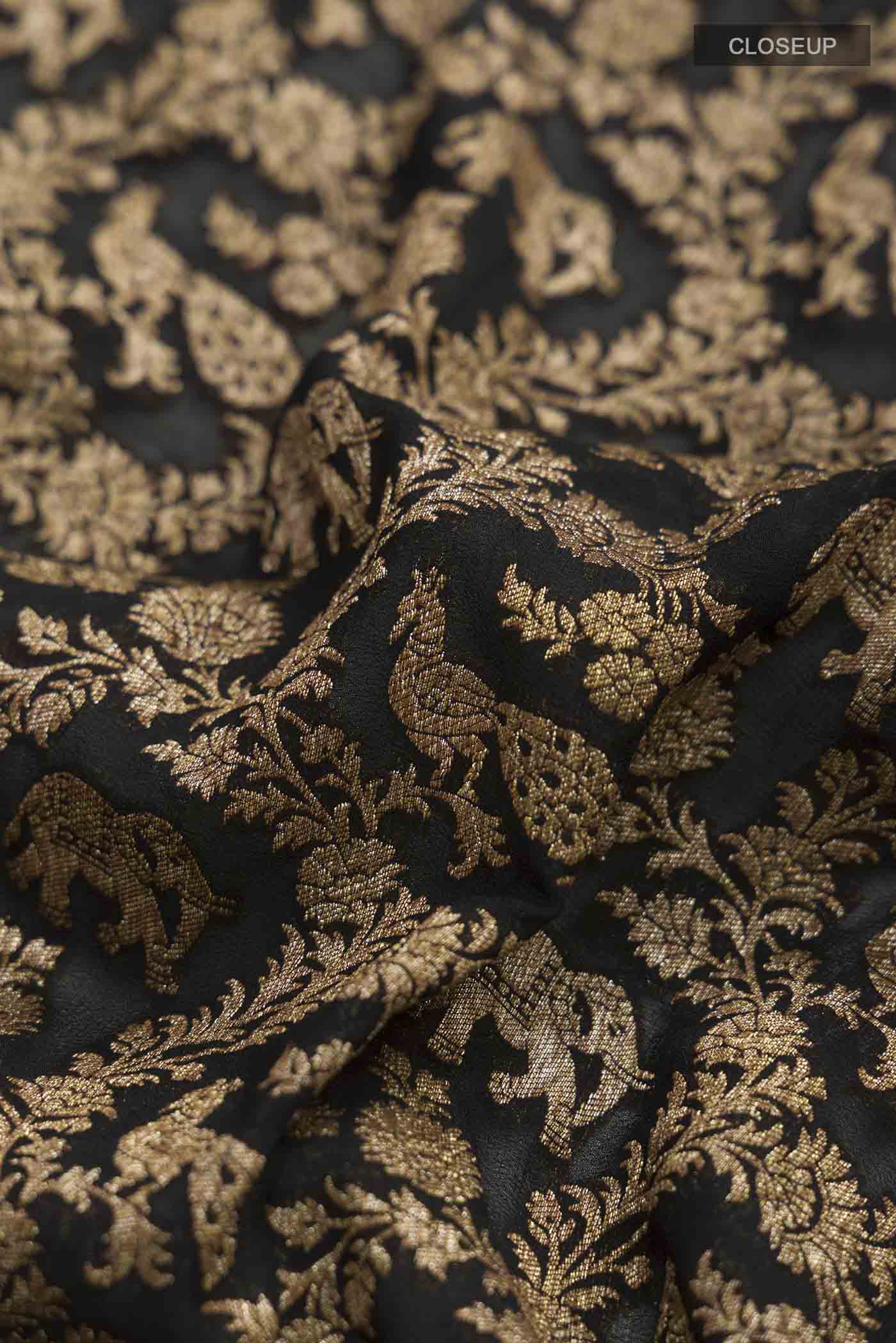Close up of Black Banarasi Georgette Saree with Zari Brocade on the body and Zari Border displaying folds