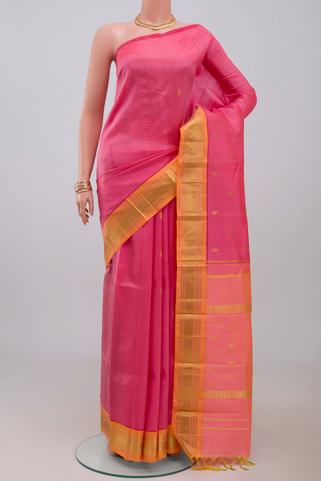 Pink Kanjivaram Saree with Zari Butta on the body and One Side Border.  displayed on a mannequin
