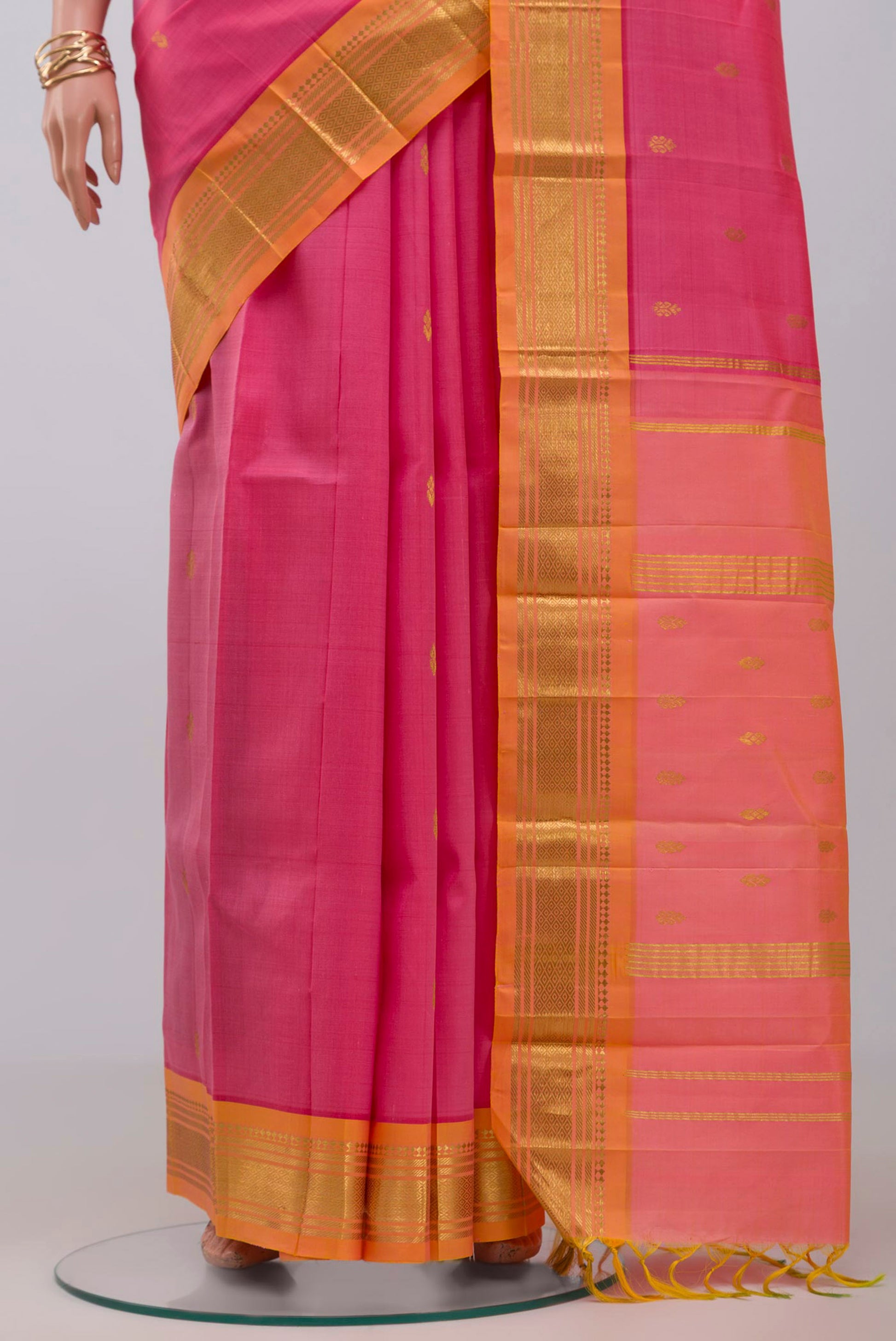 Pleats and pallu of Pink Kanjivaram Saree with Zari Butta on the body and One Side Border. 