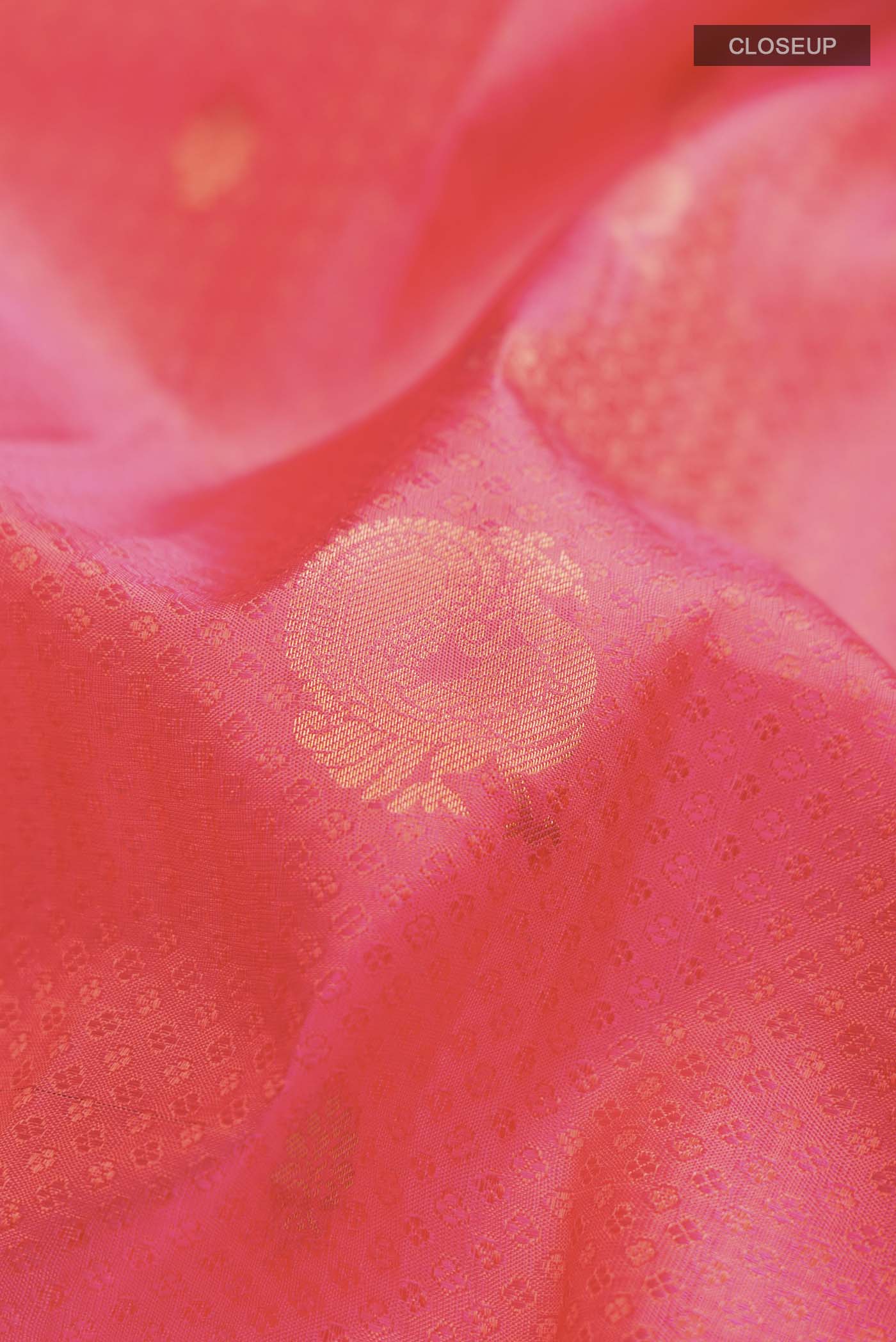 Close up of Pink with Orange Color Kanchipuram Silk Saree with Jacquard With Zari Butta on the body and Zari Border displaying folds